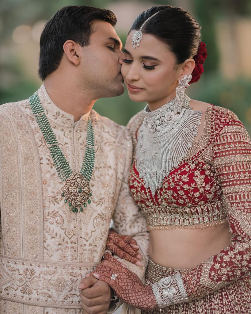 Indian bride and groom wearing diamond and emerald jewellery