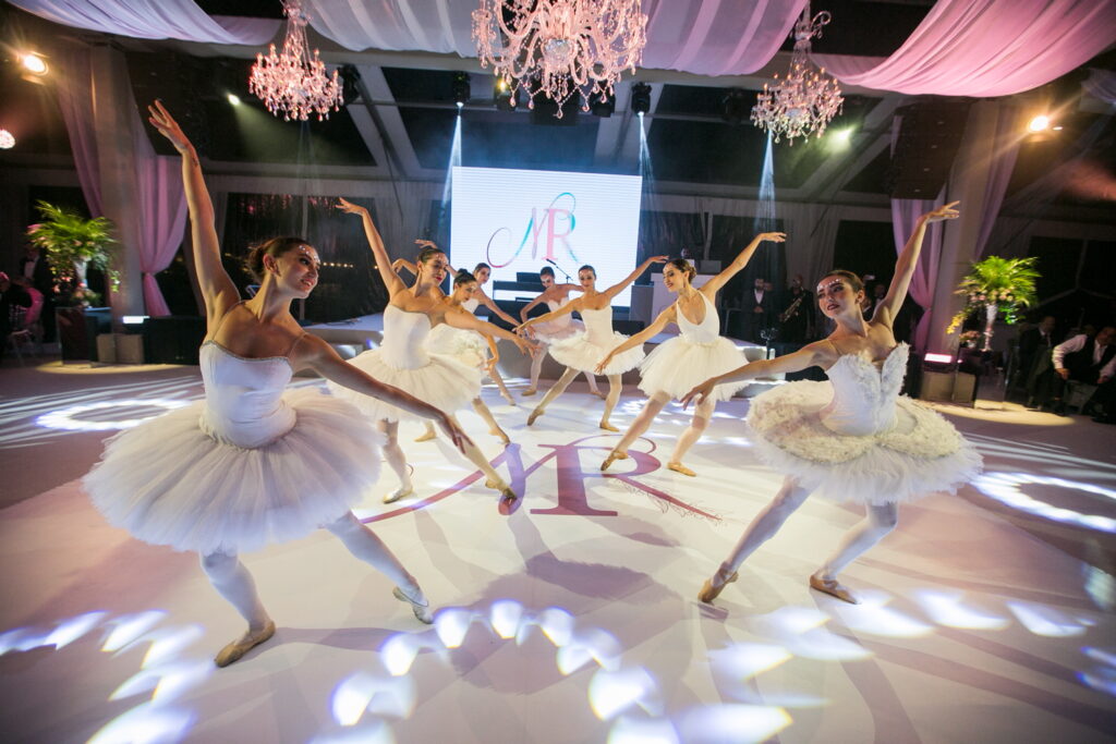 Ballet dancers performing in white dresses