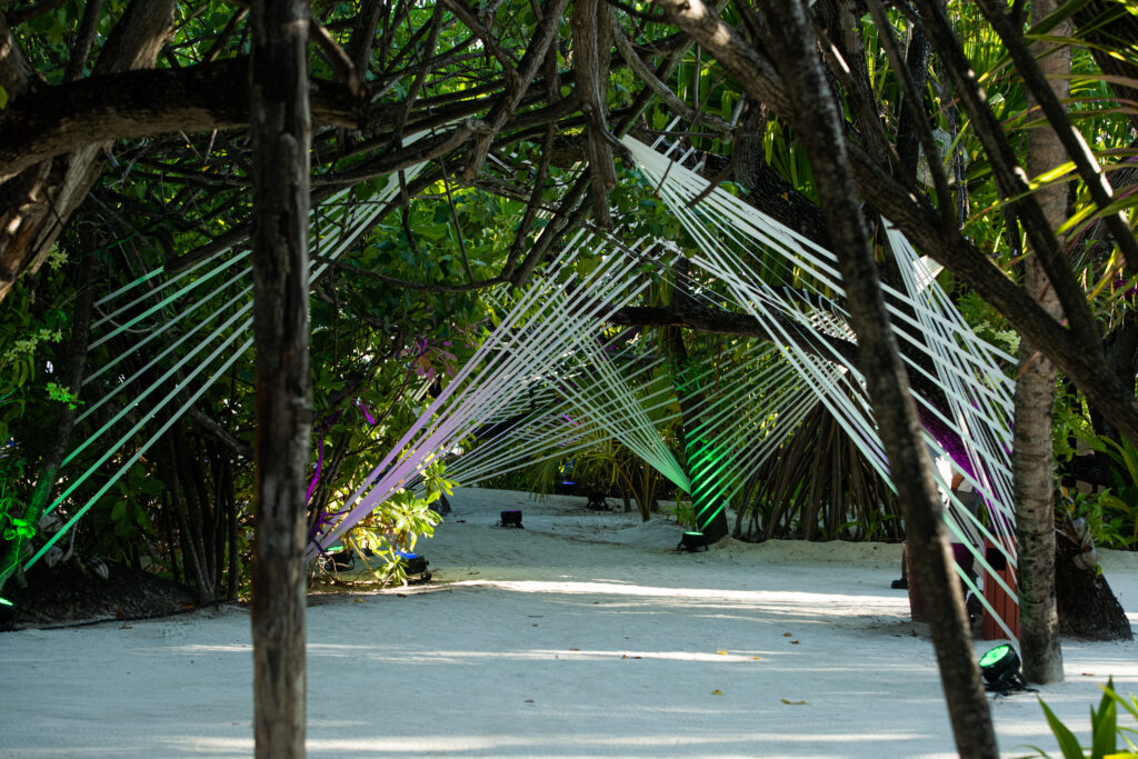 white string welcome party decor at the beach