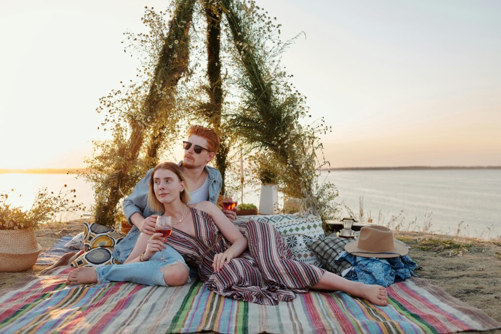 Couple enjoying afternoon tea picnic by the beach