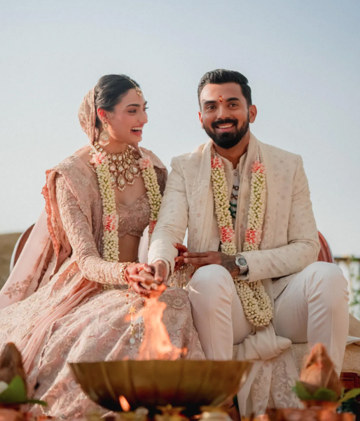 Indian bride and groom smiling while performing wedding ceremony