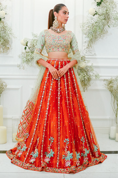 girl wearing mint green and orange lehenga set