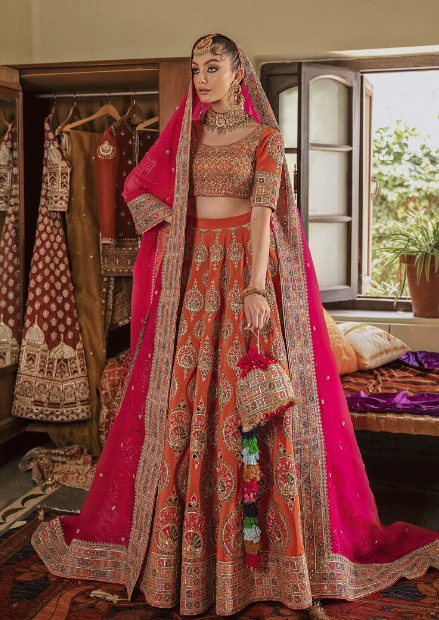 girl wearing a pink and orange wedding lehenga set