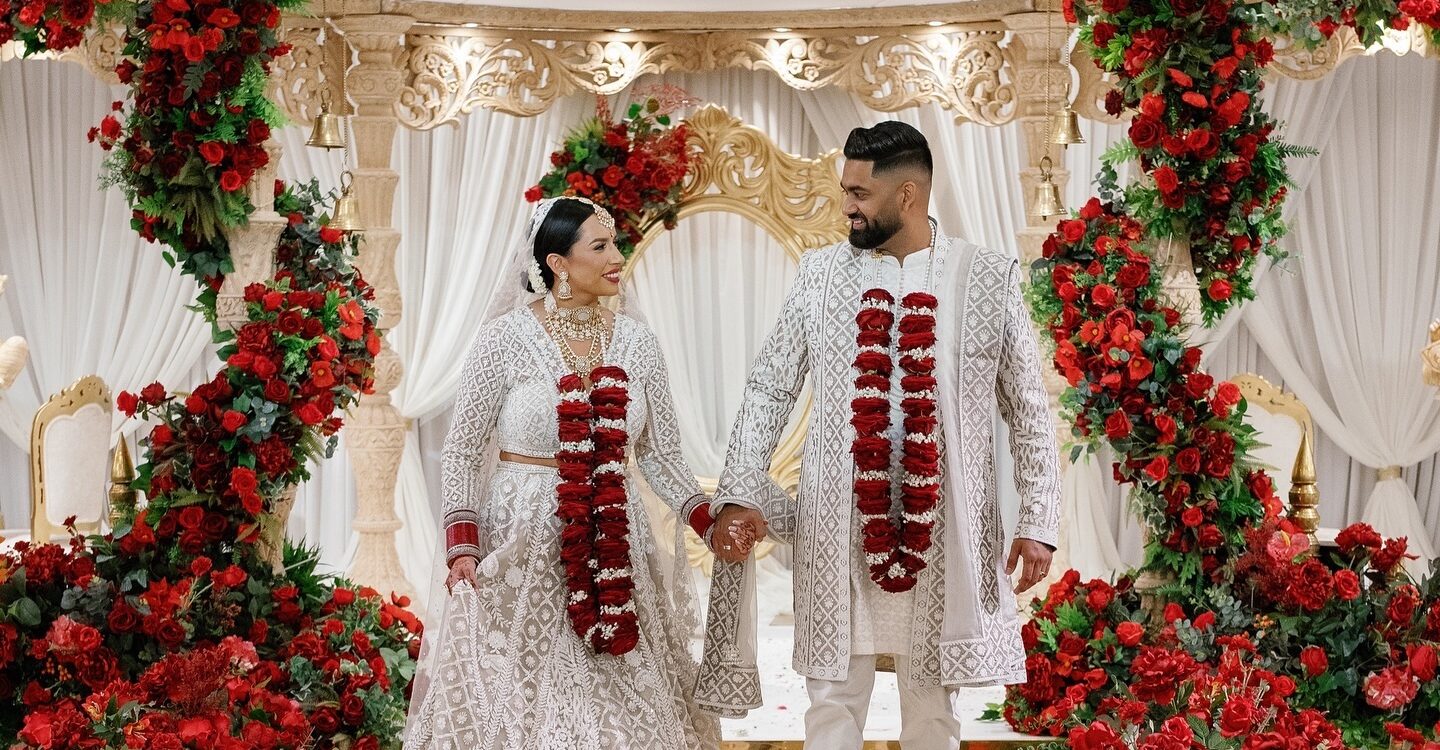 Indian bride and groom walking down the aisle