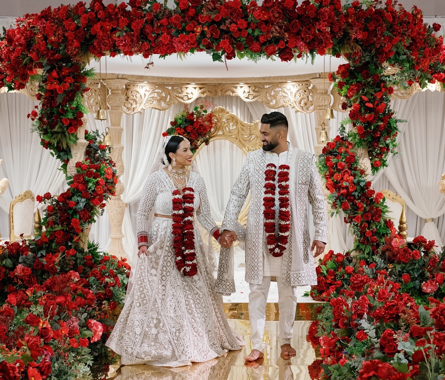 Indian bride and groom walking down the aisle